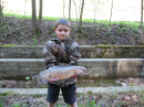 Child holds a fish.